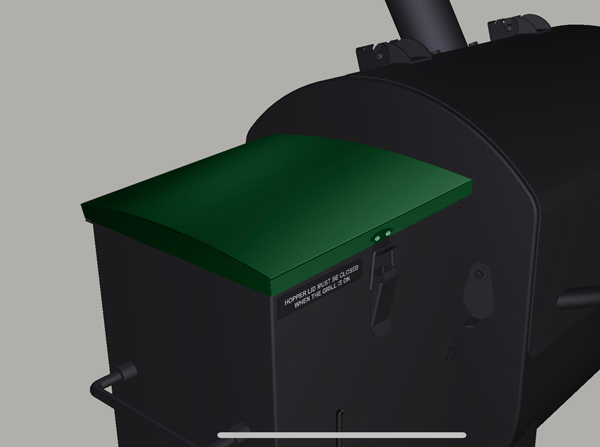 Hopper lid of Green Mountain Grills TREK Prime 2.0 pellet grill, featuring a green finish and warning label about keeping the lid closed during operation.